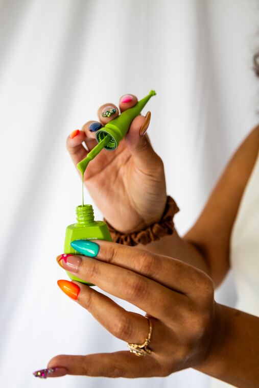 Painted nails and a handful of polish bottles
