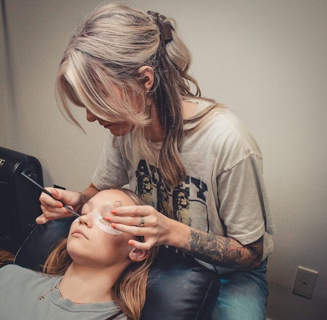 Kyndal applying lash extensions to a client